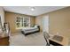 Bedroom featuring neutral walls, standard furniture, and a large window to the backyard at 6378 Grey Fox Way, Riverdale, GA 30296