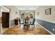 Elegant dining room with hardwood floors, stylish chandelier, and natural light at 6378 Grey Fox Way, Riverdale, GA 30296