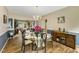 Open dining room showcasing a modern chandelier, seating for six, and wood floors at 6378 Grey Fox Way, Riverdale, GA 30296