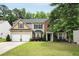 Charming two-story home with a well-manicured lawn, two-car garage, and tasteful landscaping at 6378 Grey Fox Way, Riverdale, GA 30296