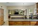 Open-concept kitchen with wooden cabinetry, a breakfast bar, and view into the living room at 6378 Grey Fox Way, Riverdale, GA 30296