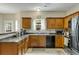 Well-maintained kitchen featuring wooden cabinetry, stainless steel appliances, and tiled floors at 6378 Grey Fox Way, Riverdale, GA 30296