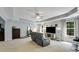 Bright living room with plush carpet, a gray sofa, and natural light from the windows at 6378 Grey Fox Way, Riverdale, GA 30296