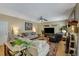 Spacious living room with ceiling fan, comfortable seating, and a large TV at 6378 Grey Fox Way, Riverdale, GA 30296