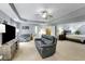 Open living room and bedroom area with a plush gray sofa, television and large bedroom at 6378 Grey Fox Way, Riverdale, GA 30296