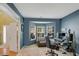 Bright home office featuring large windows, ample desk space, and neutral décor at 6378 Grey Fox Way, Riverdale, GA 30296