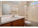 Bathroom featuring a vanity, mirror, and shower-tub combo at 115 Manx Dr, Grantville, GA 30220