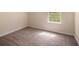 Bedroom with neutral walls and plush carpeting, illuminated by natural light from a window at 115 Manx Dr, Grantville, GA 30220