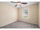 Cozy carpeted bedroom with ceiling fan and natural light from the window at 115 Manx Dr, Grantville, GA 30220