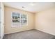 Carpeted bedroom with double window providing ample natural light at 115 Manx Dr, Grantville, GA 30220