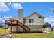 Two-story home with white siding, a deck, and a backyard at 115 Manx Dr, Grantville, GA 30220
