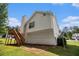Back view of house with deck, chimney, satellite dish, and landscaped yard at 115 Manx Dr, Grantville, GA 30220