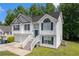 Charming two-story home featuring a two-car garage and a welcoming front entrance with a staircase at 115 Manx Dr, Grantville, GA 30220