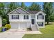 Charming two-story home featuring a two-car garage and a welcoming front entrance with a staircase at 115 Manx Dr, Grantville, GA 30220