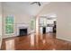 Open living room features hardwood floors, fireplace, and access to a deck and kitchen at 115 Manx Dr, Grantville, GA 30220