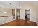 Elegant living room with hardwood floors showing staircase and kitchen area at 115 Manx Dr, Grantville, GA 30220