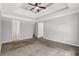 Spacious bedroom with tray ceiling, ceiling fan, and neutral colors at 4115 Kensington Cv, Atlanta, GA 30349