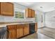 Kitchen featuring wood cabinets, a black dishwasher and double sink at 4115 Kensington Cv, Atlanta, GA 30349