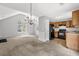 Open concept living space with a kitchen and living room featuring neutral color palette at 4115 Kensington Cv, Atlanta, GA 30349