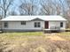 Charming one-story home boasting a durable metal roof, vinyl siding, and inviting front porch with natural light at 7301 Staton Se Pl, Acworth, GA 30102