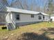 Attractive single-story home with a covered porch and vinyl siding and a spacious front yard perfect for outdoor activities at 7301 Staton Se Pl, Acworth, GA 30102