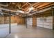The unfinished basement with exposed pipes and a painted floor holds the potential for future expansion at 12 Woodland St, Dallas, GA 30157