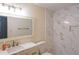 Updated bathroom featuring marble countertop vanity, modern fixtures, and tiled shower at 12 Woodland St, Dallas, GA 30157