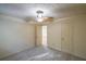 This bedroom boasts neutral carpet and walls, along with a ceiling fan and two convenient closets at 12 Woodland St, Dallas, GA 30157