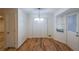 Open dining area with hardwood floors, modern lighting fixture, and convenient closet space at 12 Woodland St, Dallas, GA 30157