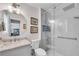 Modern bathroom featuring a glass-enclosed shower, a marble vanity, and stylish light fixtures at 2500 Madison Commons, Atlanta, GA 30360