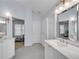 Bathroom featuring double vanity sinks, updated fixtures, and a view into the main bedroom at 2500 Madison Commons, Atlanta, GA 30360