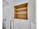 Built-in bathroom cabinet provides ample storage space with adjustable shelves and white doors at 2500 Madison Commons, Atlanta, GA 30360