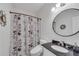 Cozy bathroom features a floral shower curtain, modern fixtures, and a decorative mirror at 2500 Madison Commons, Atlanta, GA 30360