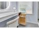 Bathroom vanity features a hidden compartment for extra storage near the window and a makeup mirror at 2500 Madison Commons, Atlanta, GA 30360