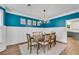Formal dining room with wainscoting, hardwood flooring and elegant lighting at 2500 Madison Commons, Atlanta, GA 30360