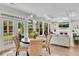 Dining area with backyard views through large windows and doors at 2500 Madison Commons, Atlanta, GA 30360