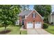 Classic two-story brick home with an attached two-car garage and lovely curb appeal at 2500 Madison Commons, Atlanta, GA 30360