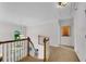 Bright hallway showcasing hardwood staircase, carpet runner, and stylish lighting at 2500 Madison Commons, Atlanta, GA 30360