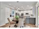 Kitchen and dining area with table set and backyard view from the doorway at 2500 Madison Commons, Atlanta, GA 30360