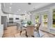 Kitchen and dining area with table set and backyard view from the doorway at 2500 Madison Commons, Atlanta, GA 30360