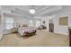 Spacious main bedroom with tray ceiling, neutral carpet, and sitting area at 2500 Madison Commons, Atlanta, GA 30360