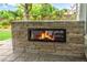 Outdoor stone fireplace creating a cozy ambiance for outdoor gathering at 2500 Madison Commons, Atlanta, GA 30360