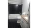 Full bathroom featuring dark tile flooring, tub with shower, and vanity at 4274 Carrollwood Dr, Stone Mountain, GA 30083