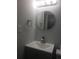 Updated half-bathroom featuring modern vanity, brushed nickel faucet, and gray walls at 4274 Carrollwood Dr, Stone Mountain, GA 30083