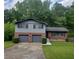 Charming split-level home with a two-car garage and a well-maintained front yard at 4274 Carrollwood Dr, Stone Mountain, GA 30083