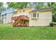 The backyard features a two-story house with a wooden deck, stairs, and a grassy lawn at 5141 Rocky Run, Stone Mountain, GA 30088