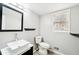 Modern bathroom featuring a stylish sink, mirror, and fixtures with wood-look flooring at 5141 Rocky Run, Stone Mountain, GA 30088