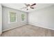 Bedroom features plush carpeting, neutral paint, and natural light from large windows at 5141 Rocky Run, Stone Mountain, GA 30088