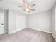 This bedroom has a ceiling fan, carpet flooring, and double door closet at 5141 Rocky Run, Stone Mountain, GA 30088