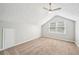 Bedroom boasts natural light from the windows and a vaulted ceiling with fan at 5141 Rocky Run, Stone Mountain, GA 30088